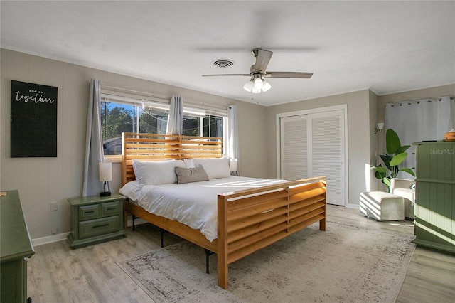 bedroom with a closet, ceiling fan, and light hardwood / wood-style floors