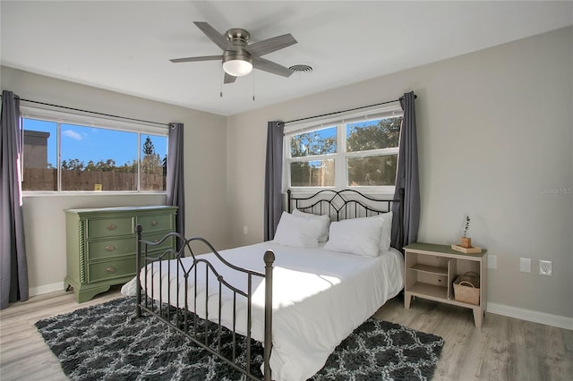 bedroom with ceiling fan and light hardwood / wood-style floors