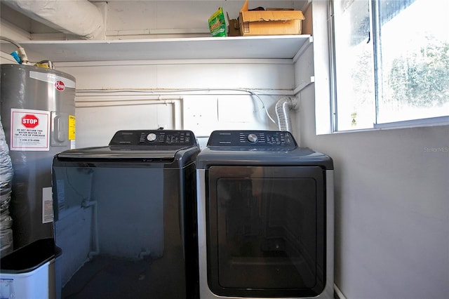 clothes washing area featuring washer and dryer and electric water heater