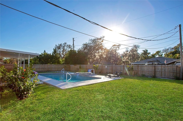 view of pool with a lawn and a patio