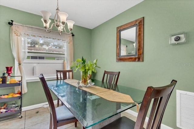 dining space featuring light tile patterned floors and a chandelier