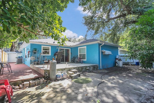 rear view of house with a patio and central air condition unit