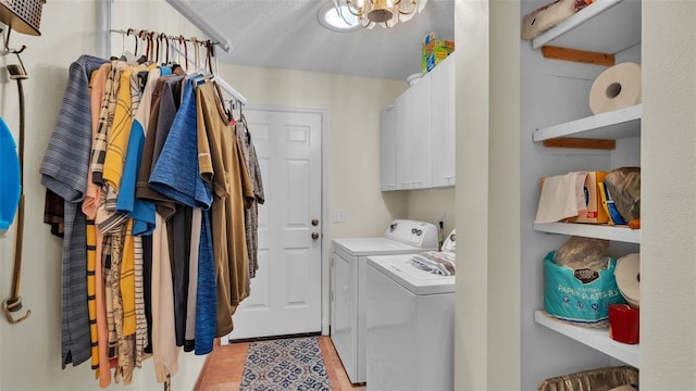 laundry room featuring separate washer and dryer, light tile patterned floors, cabinets, and a textured ceiling