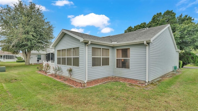 view of home's exterior with a yard