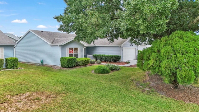 view of front of property with a garage and a front lawn