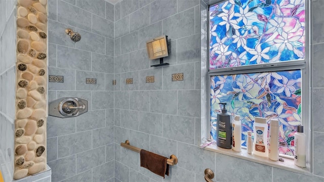 bathroom with a tile shower