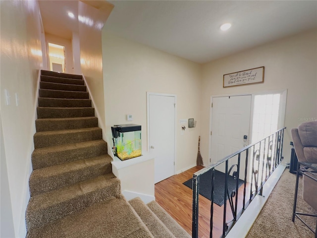 stairs with hardwood / wood-style flooring