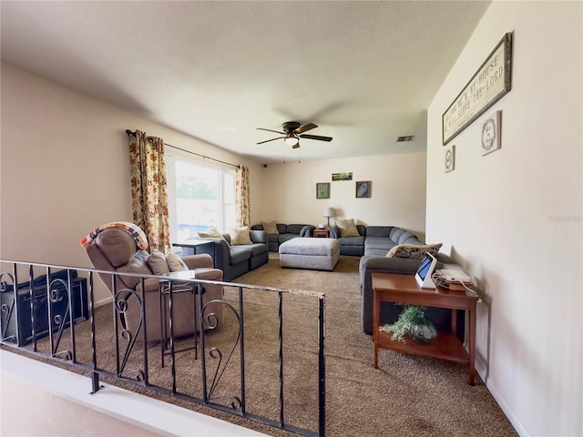 carpeted living room with ceiling fan