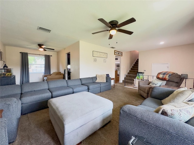 carpeted living room with ceiling fan