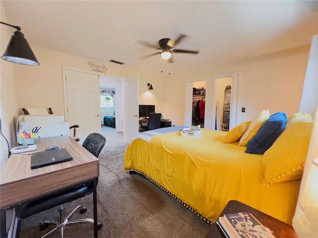 bedroom with ceiling fan, a walk in closet, a closet, carpet floors, and ensuite bath