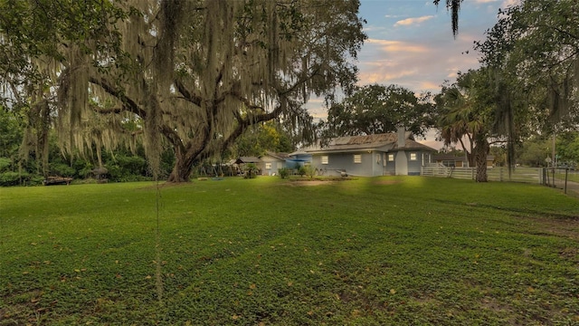 view of yard at dusk