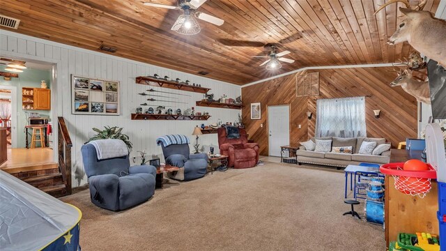 living room with ceiling fan, lofted ceiling, wood ceiling, carpet flooring, and wooden walls