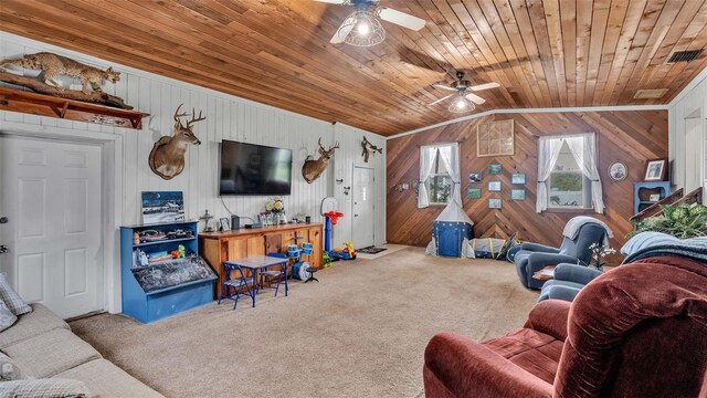 carpeted living room with ceiling fan, lofted ceiling, wood walls, ornamental molding, and wooden ceiling