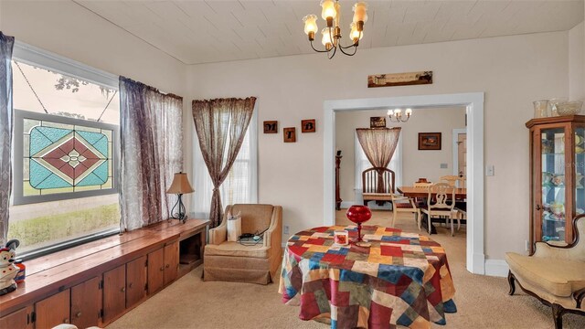 rec room featuring a notable chandelier, light carpet, and a healthy amount of sunlight