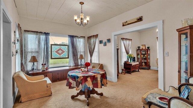 sitting room with light carpet and a notable chandelier