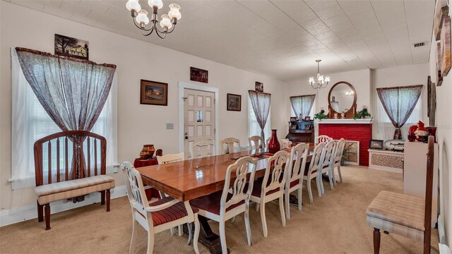 dining space with light colored carpet and an inviting chandelier