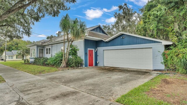 ranch-style house with a garage and a front lawn