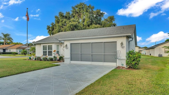 view of front of house with a garage and a front lawn