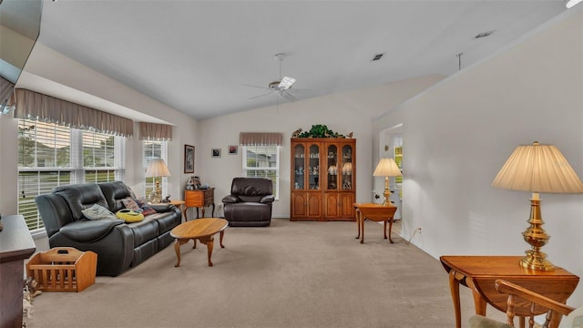 living room featuring lofted ceiling, ceiling fan, and light colored carpet