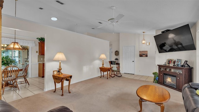 living room featuring ceiling fan with notable chandelier and light tile patterned flooring