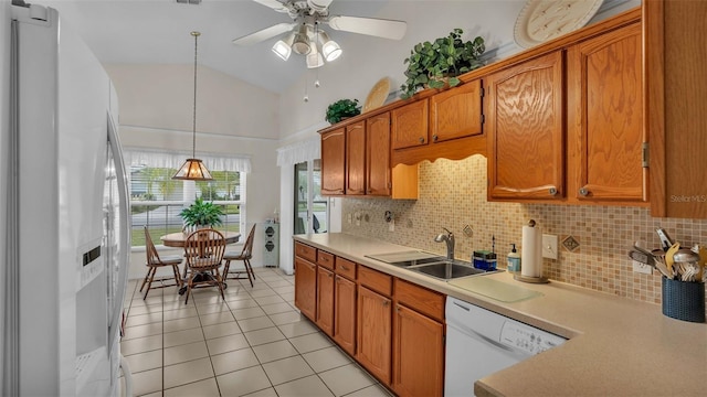 kitchen with ceiling fan, sink, white appliances, and a healthy amount of sunlight