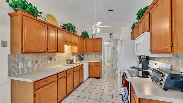 kitchen featuring sink, lofted ceiling, decorative backsplash, white appliances, and ceiling fan