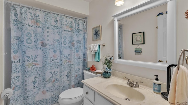 bathroom with walk in shower, vanity, and toilet