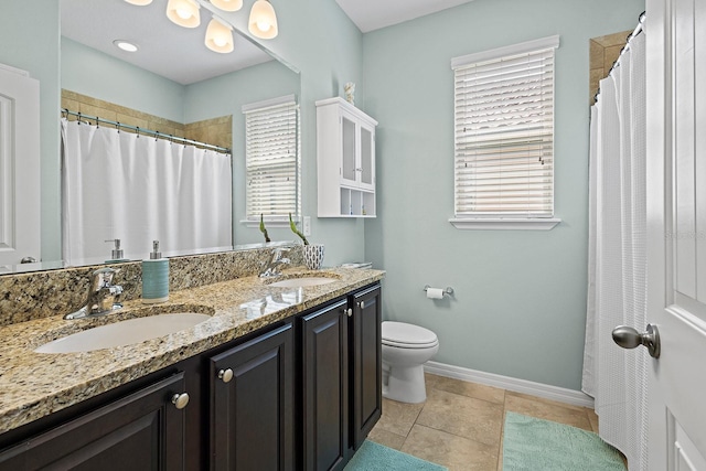 bathroom with tile patterned flooring, vanity, curtained shower, and toilet