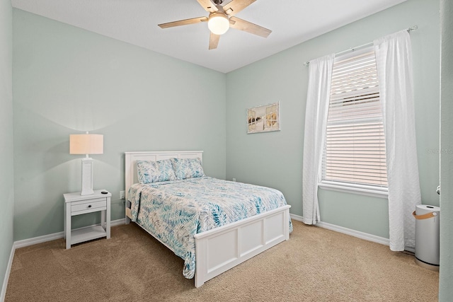 bedroom with ceiling fan, carpet floors, and multiple windows