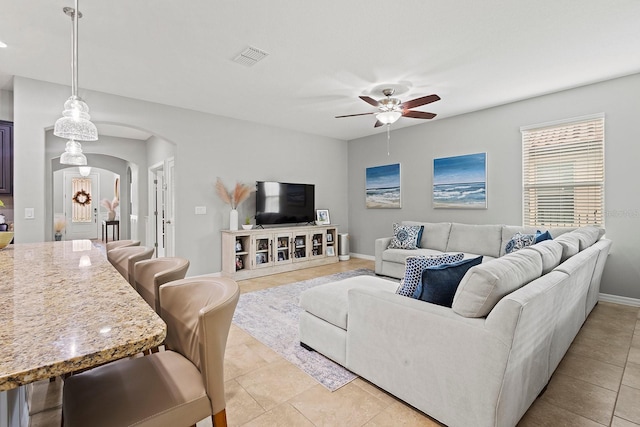 living room featuring ceiling fan and light tile patterned flooring