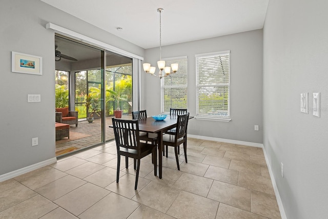 tiled dining area featuring ceiling fan with notable chandelier