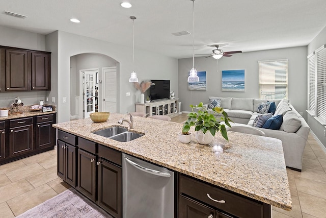 kitchen with a kitchen island with sink, sink, dark brown cabinets, and dishwasher