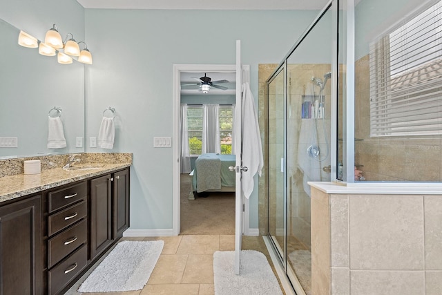 bathroom with vanity, a shower with shower door, and tile patterned flooring