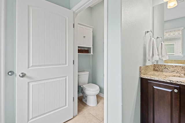 bathroom featuring tile patterned flooring, vanity, and toilet