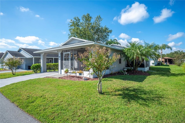 ranch-style house with a sunroom and a front lawn