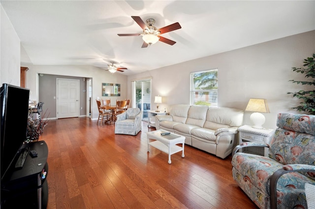 living room with vaulted ceiling, dark hardwood / wood-style flooring, and ceiling fan