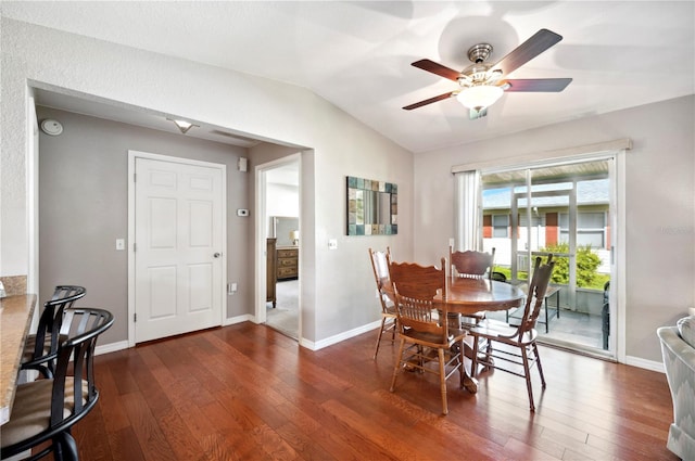 dining space featuring vaulted ceiling, dark hardwood / wood-style flooring, and ceiling fan