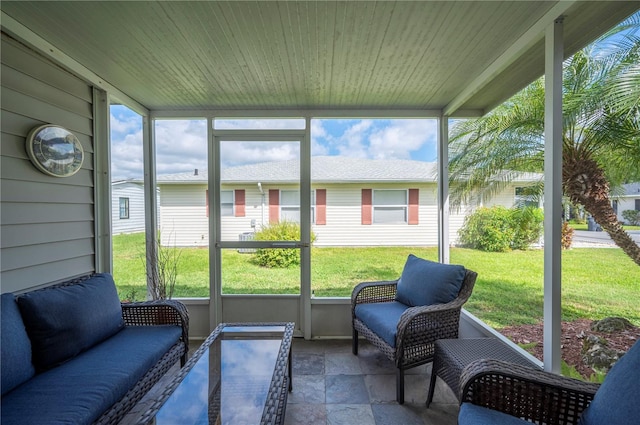 sunroom / solarium with wooden ceiling and a healthy amount of sunlight