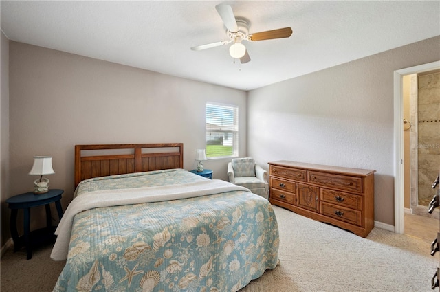 carpeted bedroom with ceiling fan and ensuite bathroom