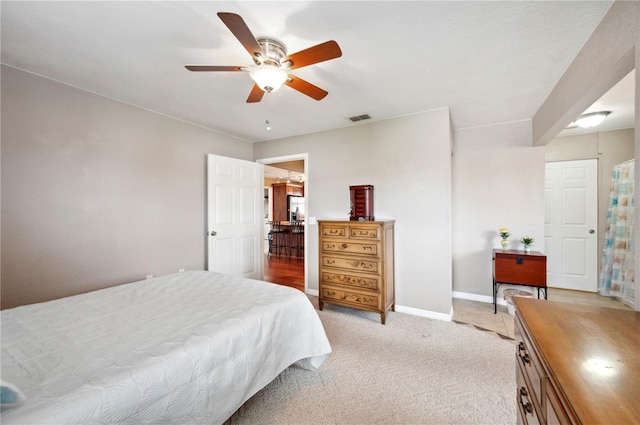 bedroom with ceiling fan and light carpet