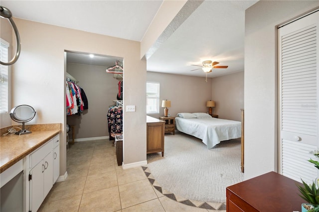 tiled bedroom featuring ceiling fan