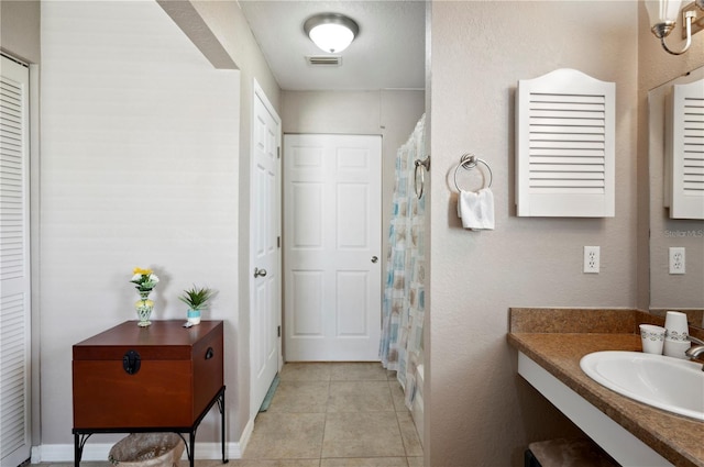 bathroom with vanity and tile patterned flooring