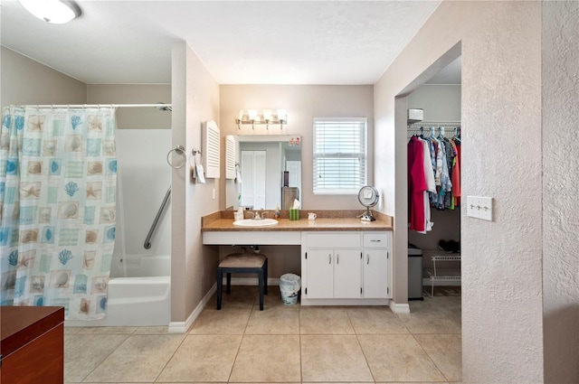 bathroom with vanity, shower / bath combo with shower curtain, and tile patterned floors