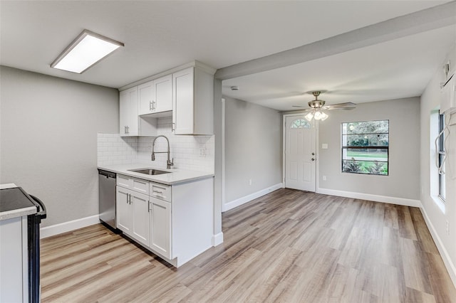 kitchen with ceiling fan, dishwasher, sink, and white cabinetry