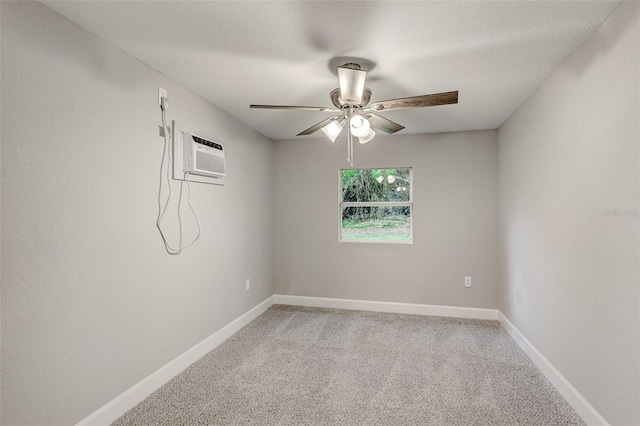 empty room featuring carpet floors, an AC wall unit, and ceiling fan