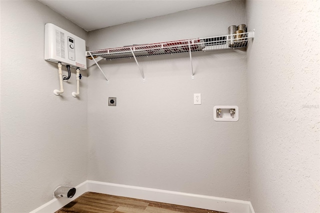 laundry area featuring washer hookup, water heater, wood-type flooring, and electric dryer hookup