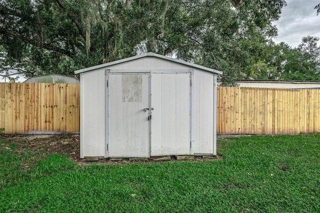 view of outbuilding with a yard