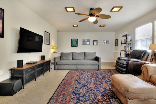 living area with carpet flooring, ceiling fan, and baseboards