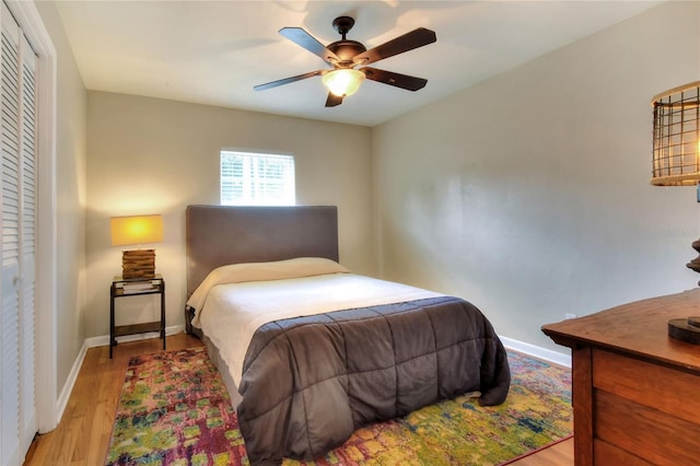 bedroom featuring baseboards, ceiling fan, and light wood-style floors