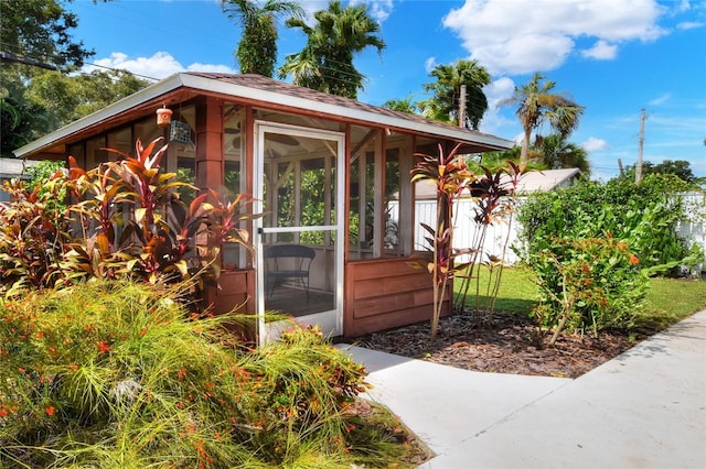 view of outdoor structure featuring a sunroom